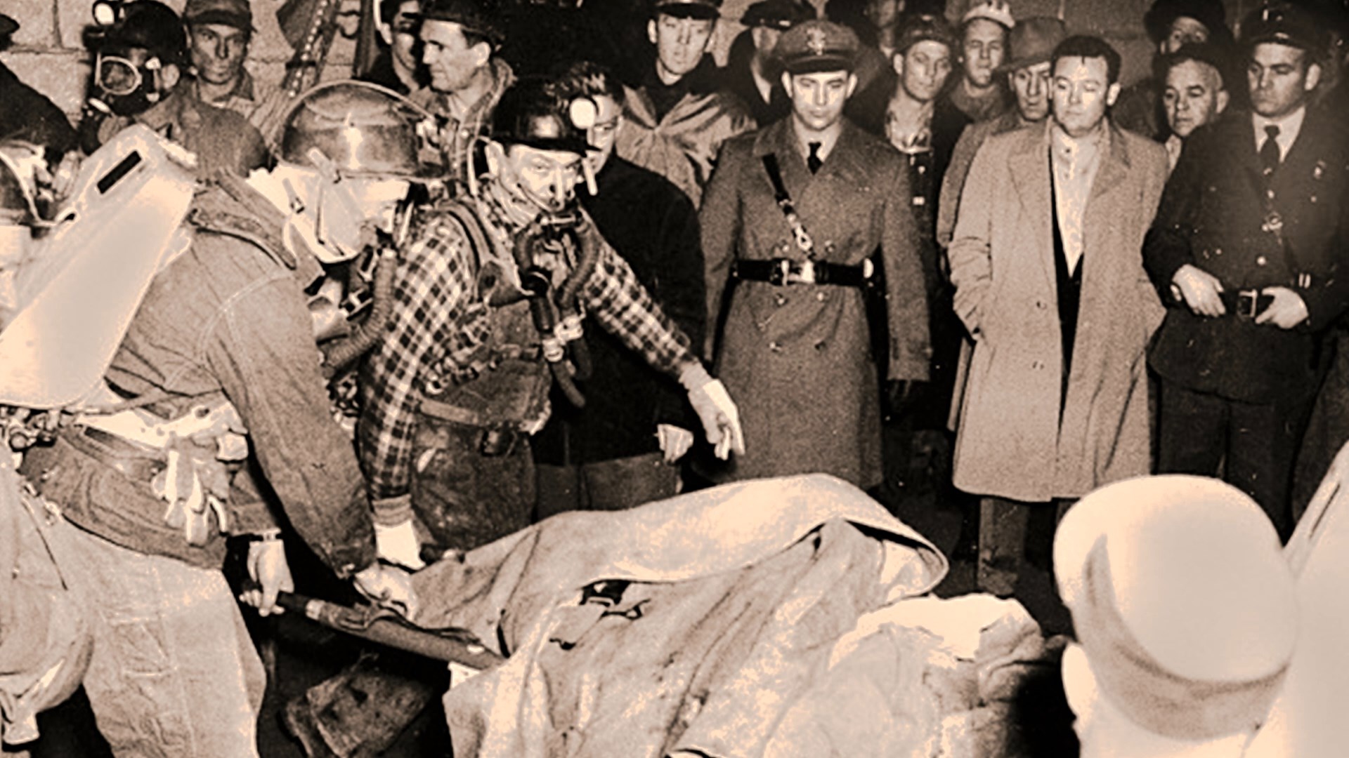 photograph from a newspaper of a body being carried out of a mine